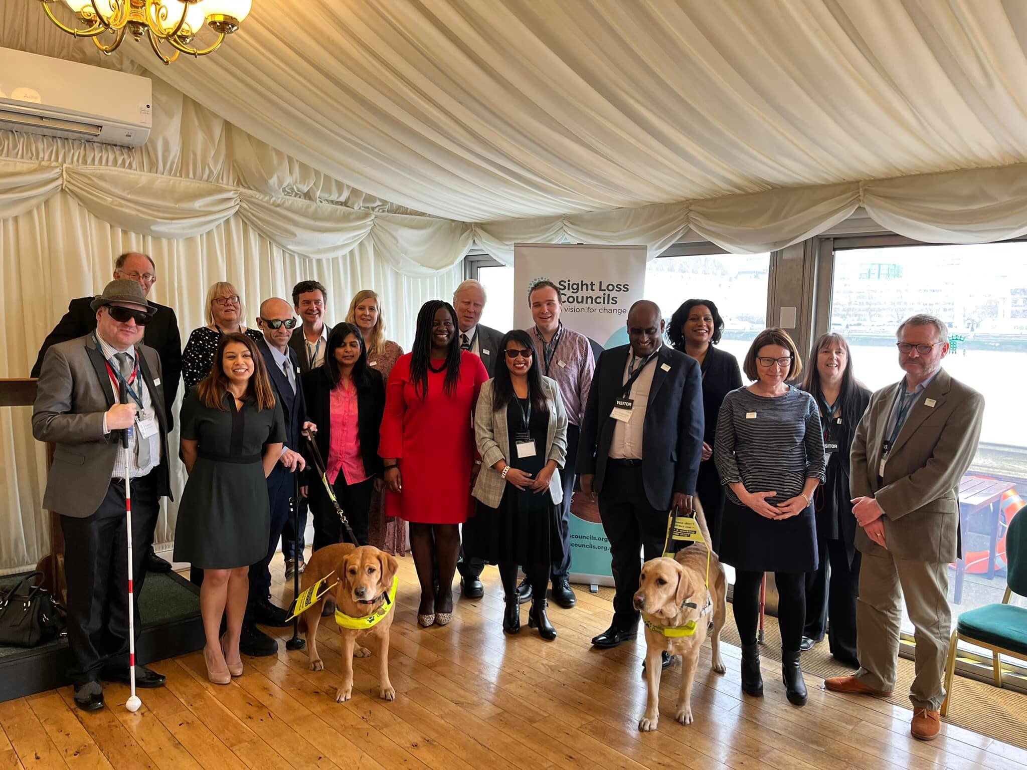A large group photo comprised of volunteers and MPs at the Houses of Parliament.