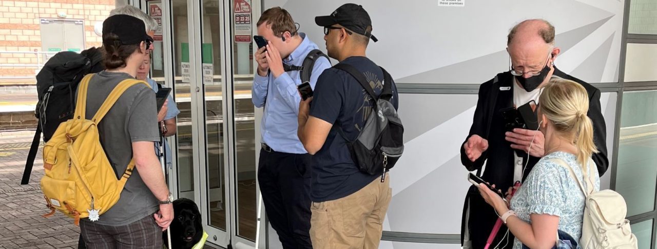 Blind and partially sighted Sight Loss Council members and Thomas Pocklington staff test out the new app at Manchester Airport Railway Station