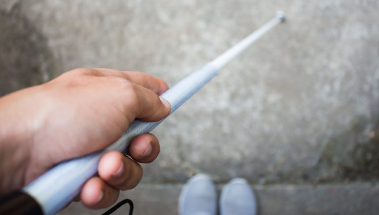 Blind person holding a white cane