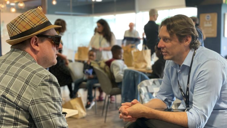 Sight Loss Council member Paul Goddard deep in conversation with Carl Martin (Govia Thameslink Railways) at the Make Transport Accessible event.