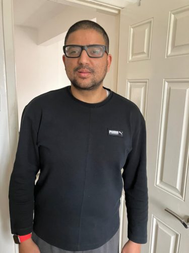 Image shows Abu-Bakr Ishtiaq from Greater Manchester SLC. He is wearing a black long sleeved top, and wearing glasses.