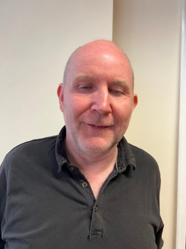 Headshot of Paul Hopkins, Birmingham SLC member. He is wearing a black shirt.