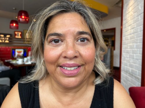 Headshot of Taryn Marshall. she has shoulder length hair and is wearing a black, sleeveless top.