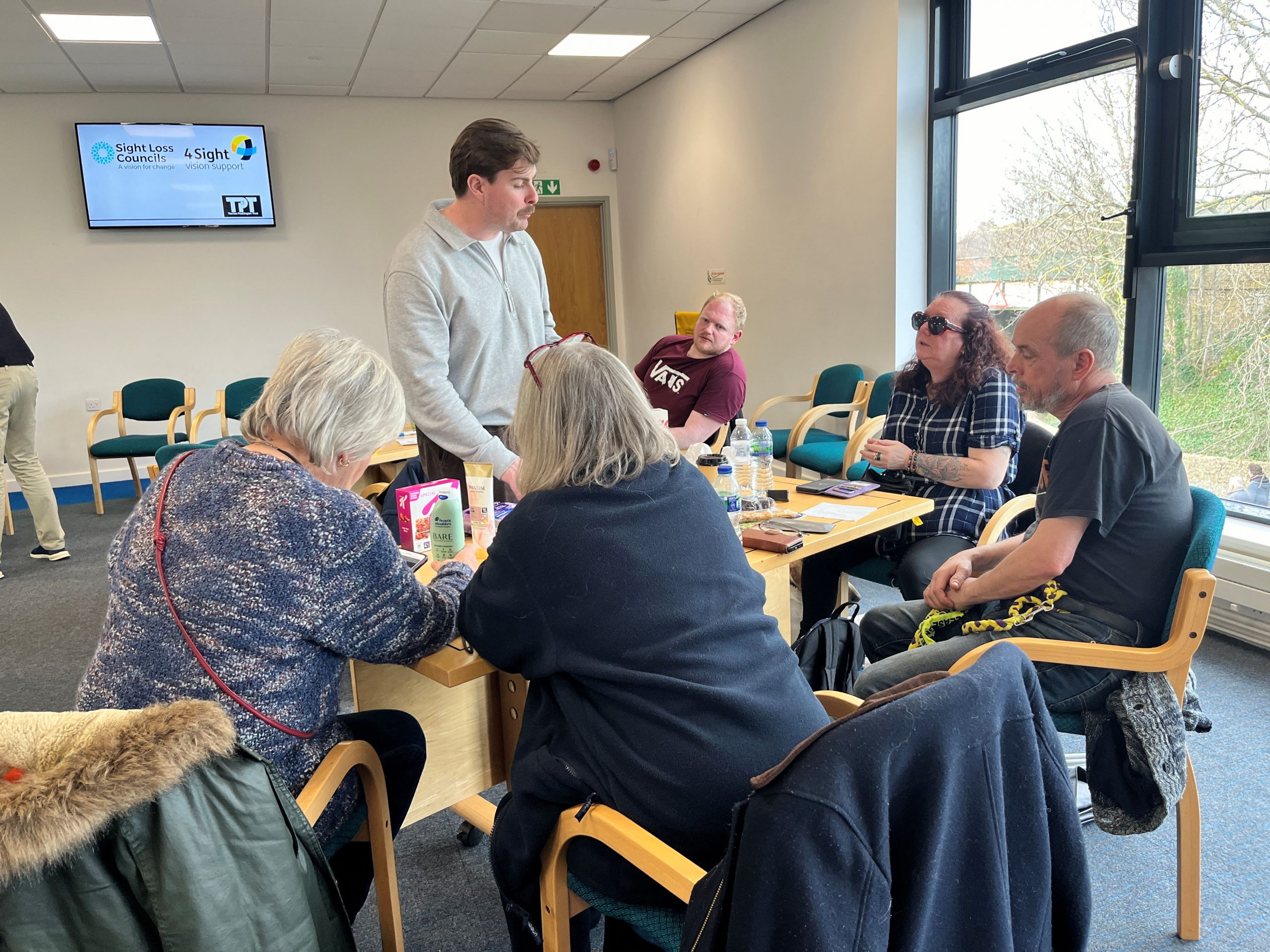 Paul Gallagher, from P&G, talking to a table of delegates at the supermarket accessibility event.