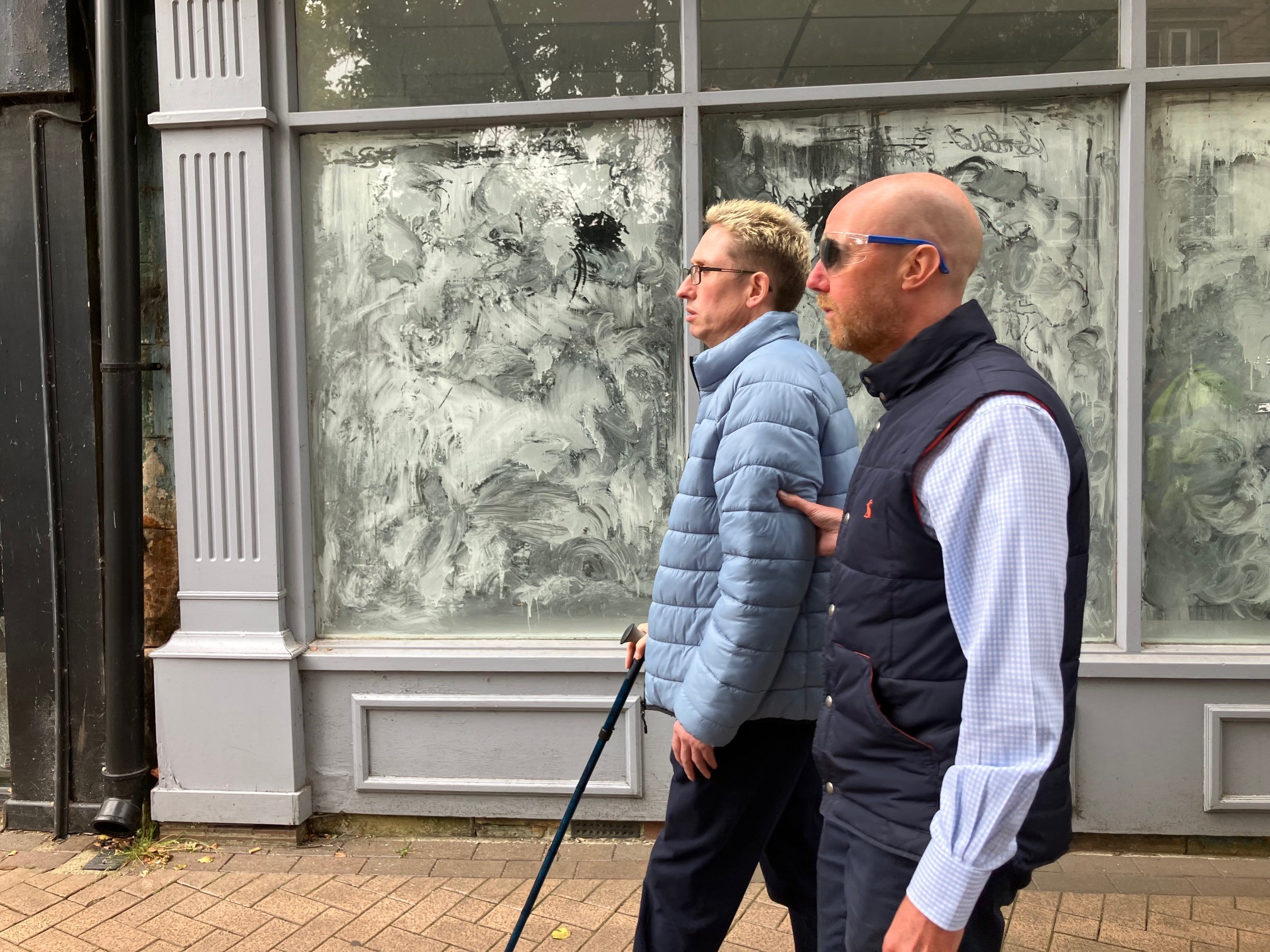 Paul Tebbitt, Policy Planner at Mansfield District Council, wearing simulation spectacles and being guided down a street to experience what it’s like to walk down a pavement with street obstacles on when living with sight loss.