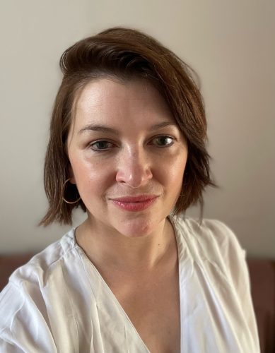 Headshot of Nicki Guy, Senior Engagement Manager, South. Nicki has a short, brown bob and is wearing a cream, v-neck top. She's smiling at the camera.