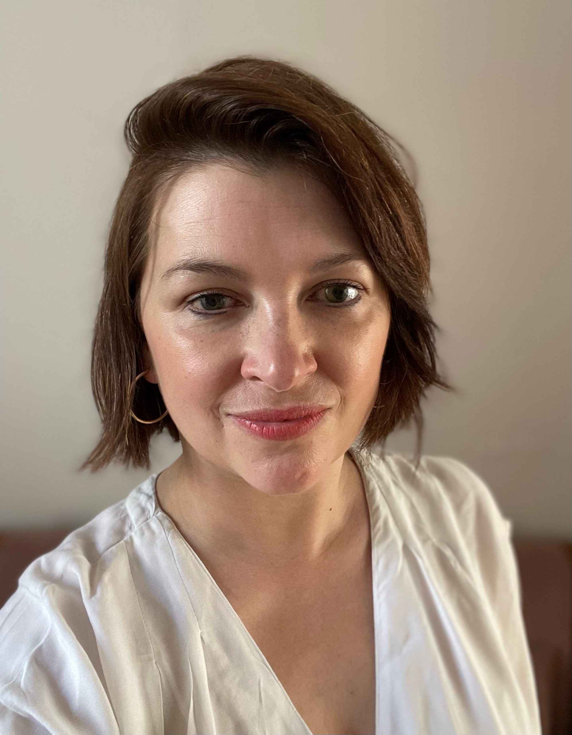 Headshot of Nicki Guy, Senior Engagement Manager, South. Nicki has a short, brown bob and is wearing a cream, v-neck top. She's smiling at the camera.