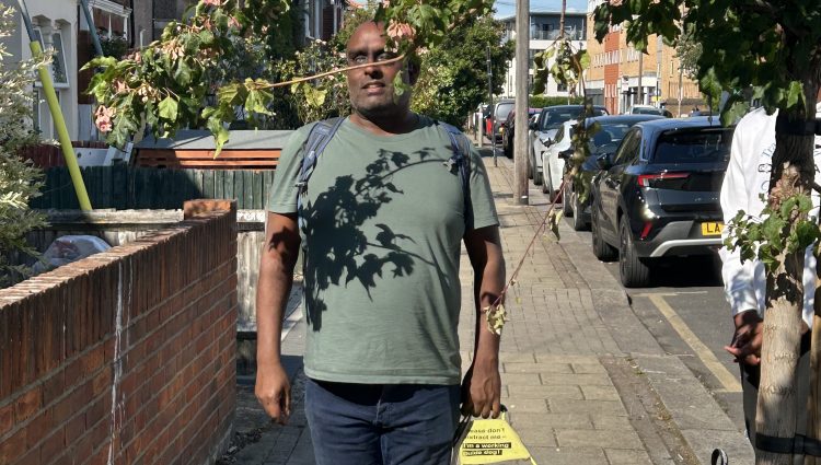 South West London SLC member pictured walking into an overhanging tree branch with his guide dog.