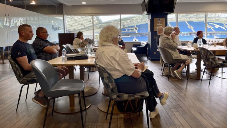 Audience members sat listening to one of the guest speakers at the Make Transport Accessible forum.
