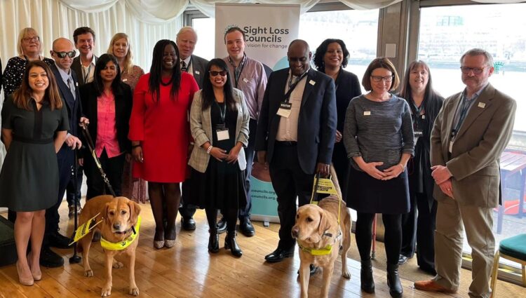 A large group photo comprised of volunteers and MPs at the Houses of Parliament.