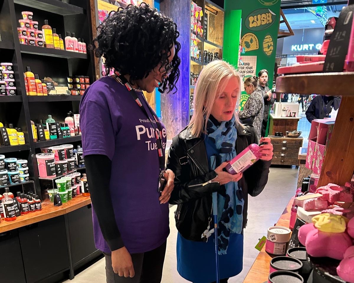 Kelly Barton, Engagement Manager for North West, is looking at beauty products in Lush with a female staff member.
