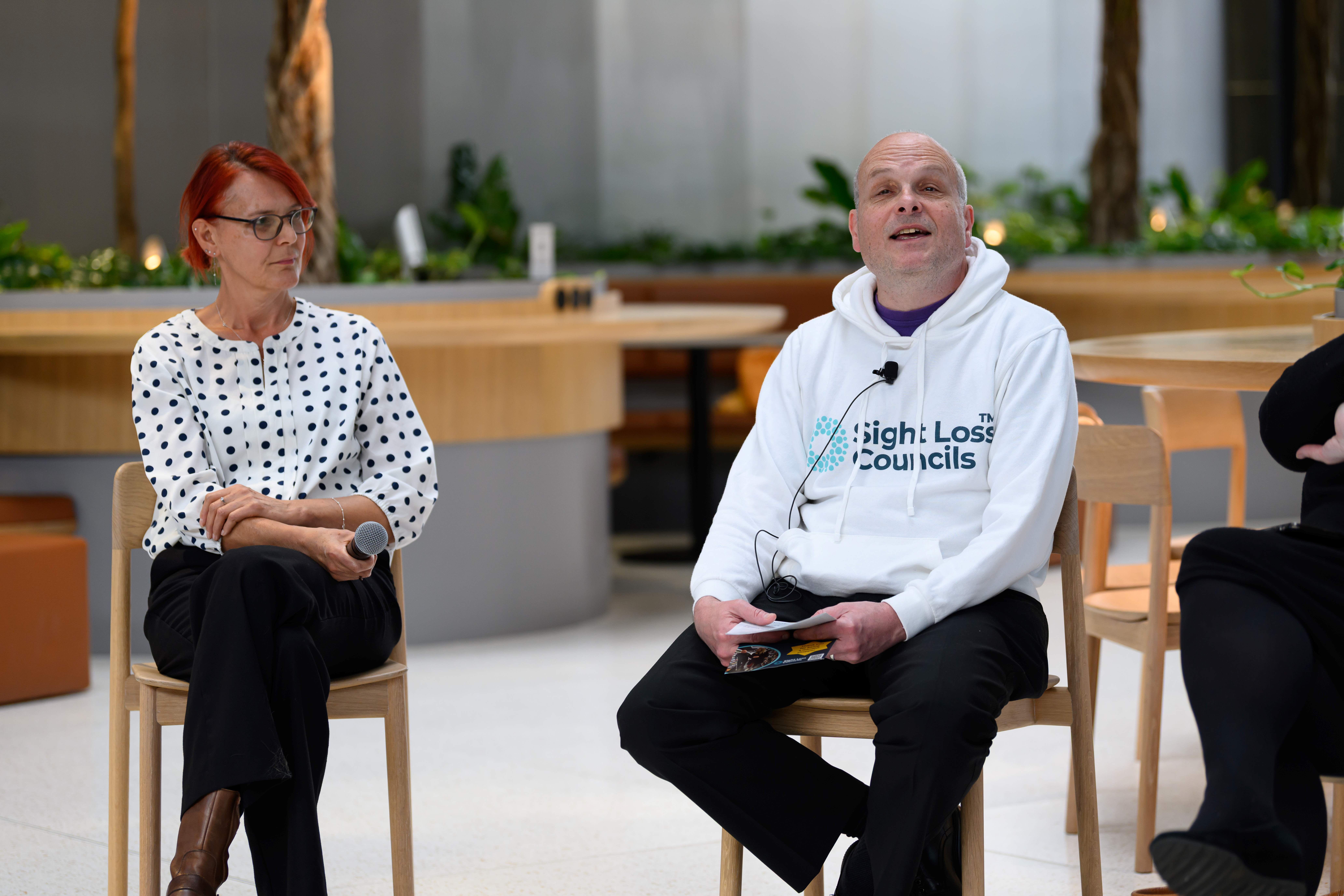 Liam O'Carroll, Acting Engagement Manager for London, speaking during the panel session. A female speaker sits to his right and is listening to what he is saying.