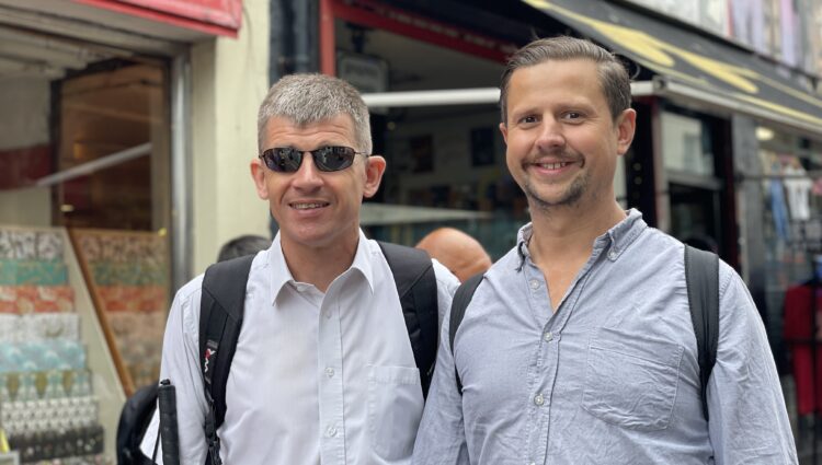 Dave Smith, Engagement Manager for the South East, pictured in Brighton with his support worker. Both are smiling at the camera.