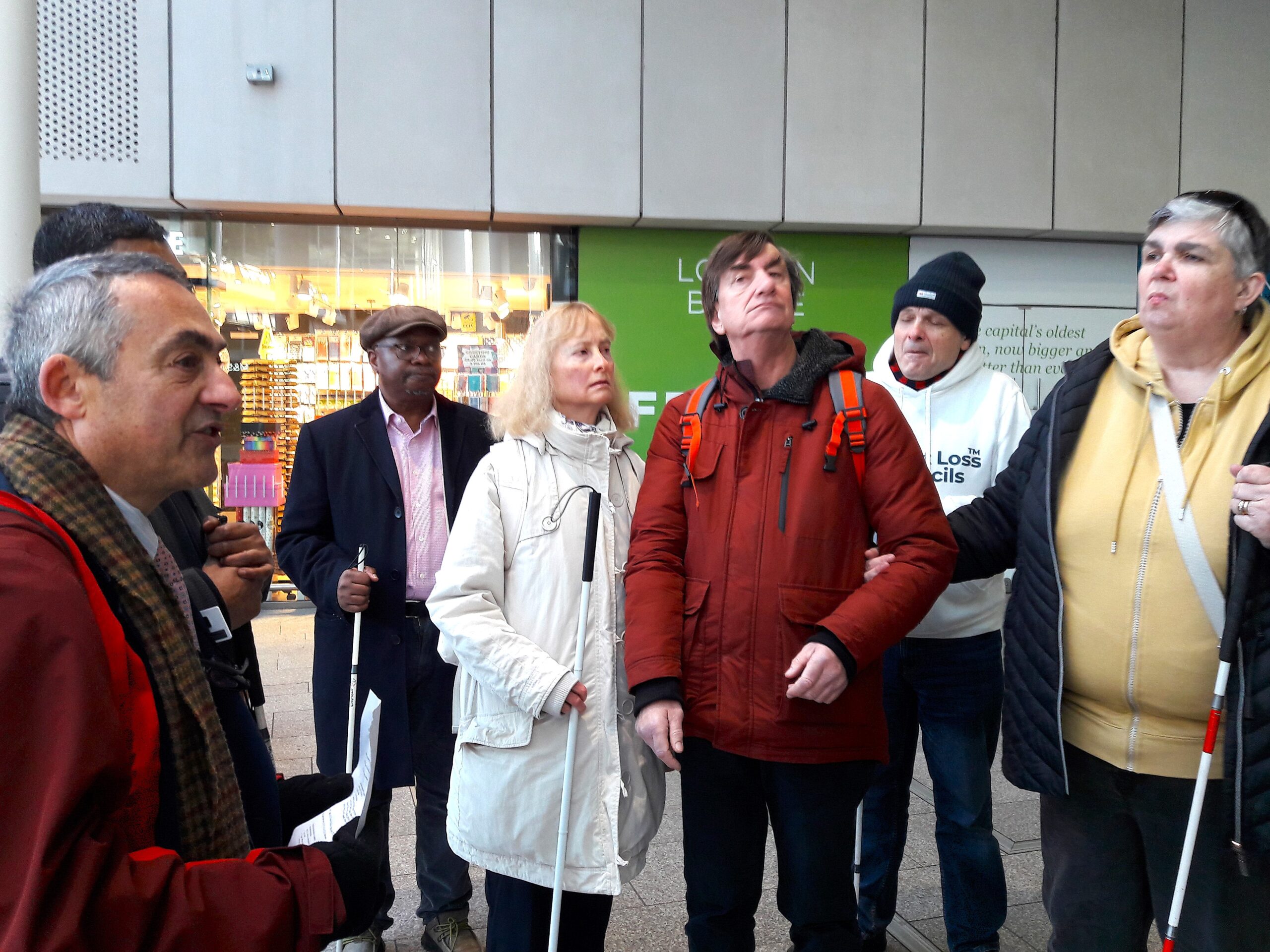 Anthony on the concourse at London Bridge speaking to the attendees who are gathered around him.