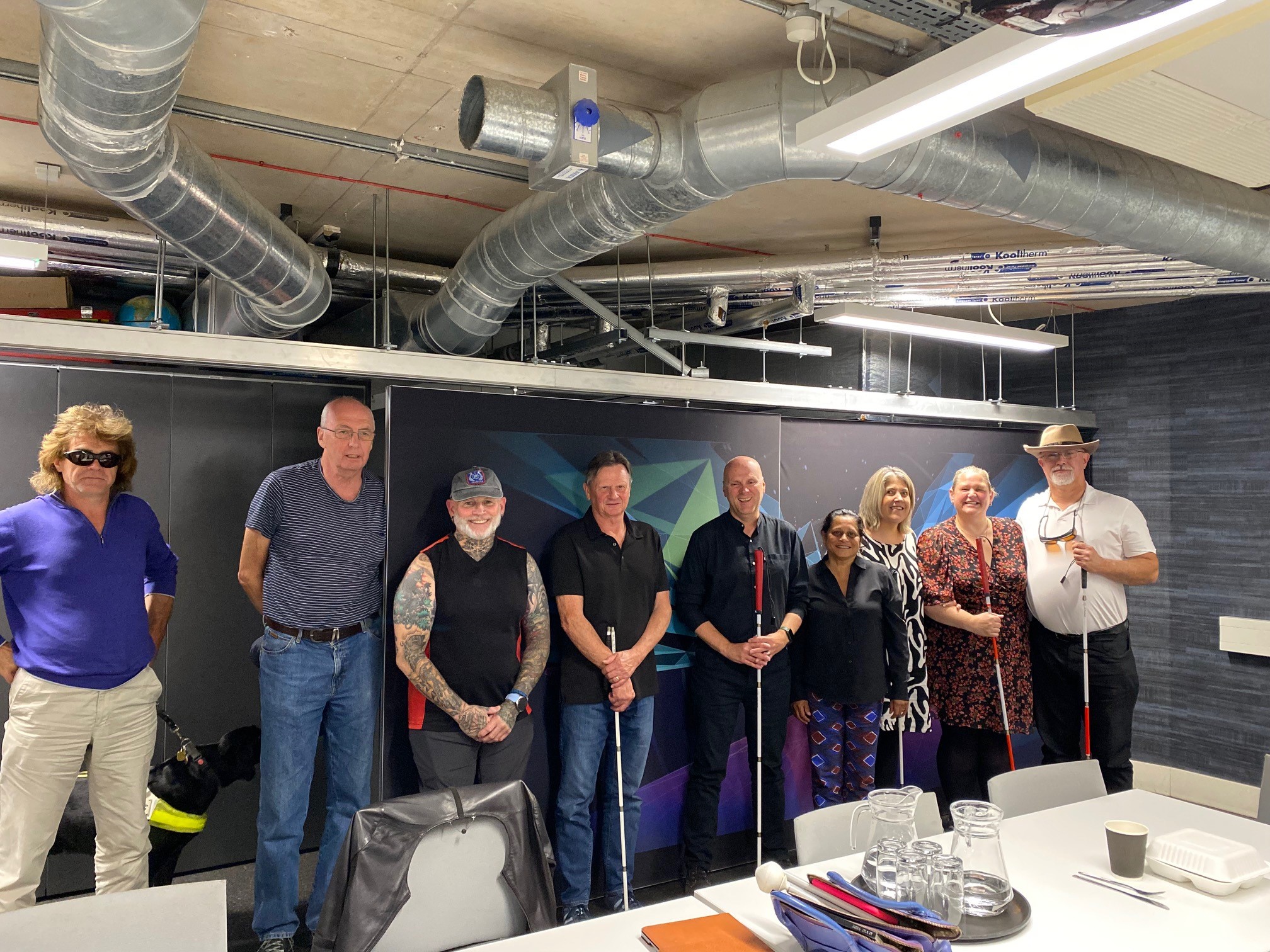 Group photo of Nottinghamshire SLC members during a visit to the Holocaust Museum. They are stood in a line, smiling at the camera.