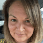 Selfie of Leigh, South Yorkshire SLC member, who is sitting in a car. She has shoulder length, light brown hair, and is smiling at the camera.