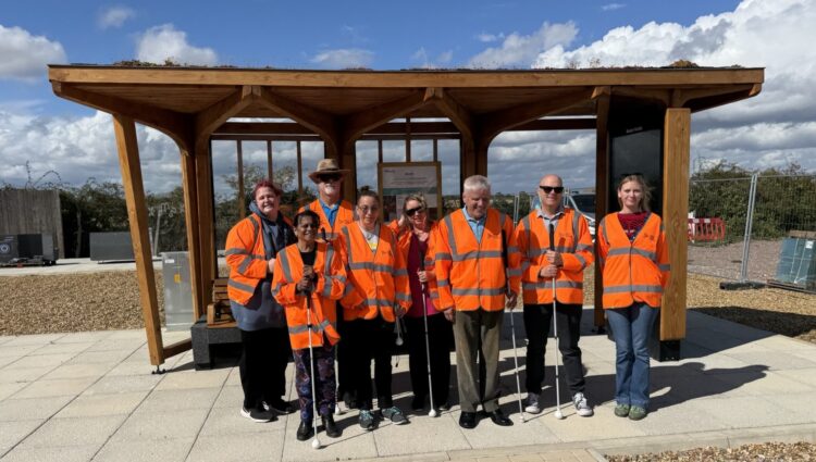 Group shot in front of a wooden test-shelter. From left to right: Dannie (Derbyshire SL); Vee (Derbyshire SLC); Jules (Derbyshire SLC); Sian (Nottinghamshire SLC); Debbie (Nottinghamshire SLC); Mike (Merseyside SLC); Matt Harrison (Engagement Manager, TPT) and Emily Roberts-Howes (Bauer Media Outdoor).