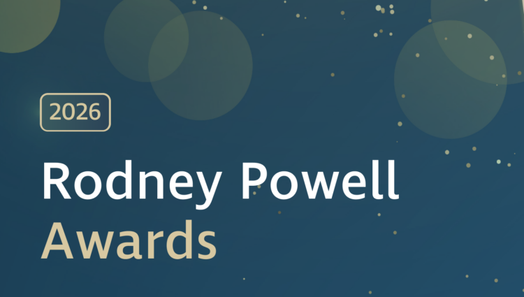 Graphic banner with a dark blue background featuring soft, translucent circles and scattered gold dots. A gold-outlined rectangle containing the text ‘2026’ appears on the left. Large white and gold text reads ‘Rodney Powell Awards.’ Decorative curved gold lines run across the right side of the image.