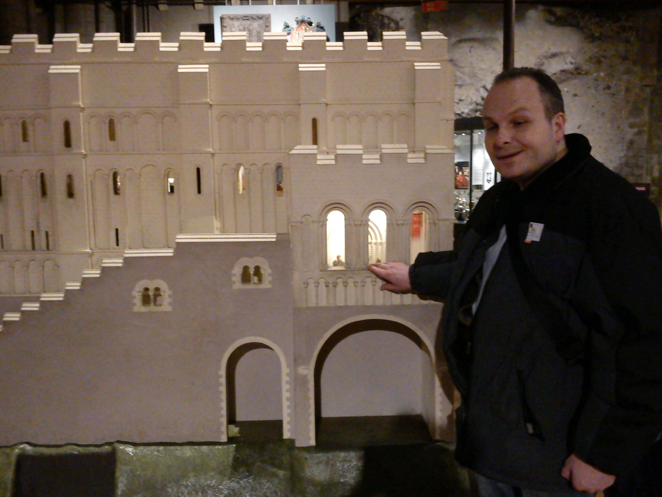 Liam O'Carroll, Interim Engagement Manager for London SLCs is photographed feeling a large model of Norwich Castle.