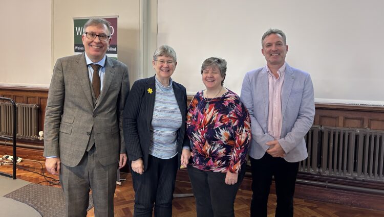 From left to right: Owen Williams, Director of Wales Council of the Blind, Jane Hutt MS, Cabinet Secretary for Social Justice, Anita Davies, Engagement Manager for Wales, and Martin Symcox, Head of Partnerships at Thomas Pocklington Trust. They are stood together in a line, smiling at the camera, during the launch event.