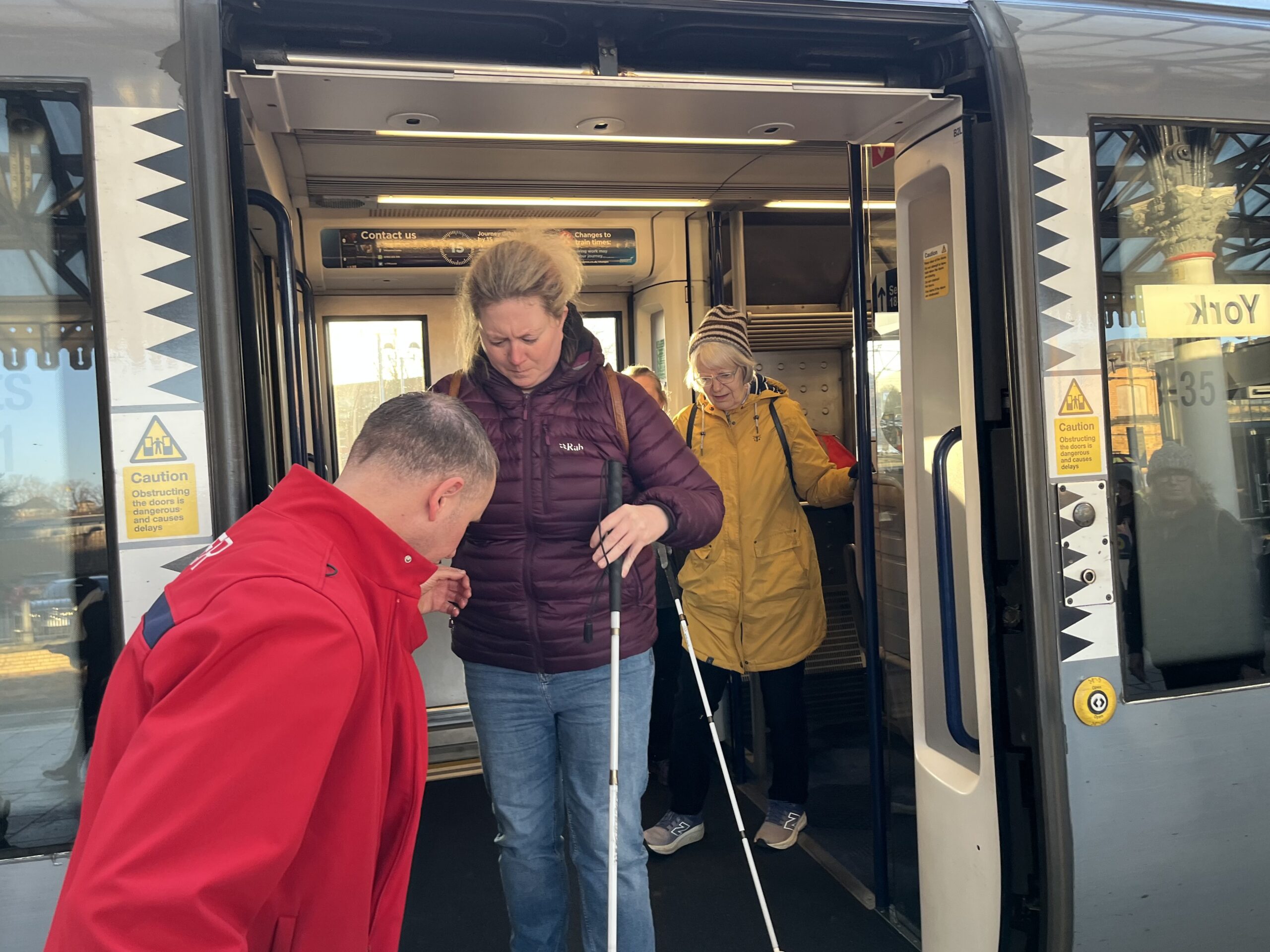 Verity, North Yorkshire SLC member, pictured stepping off the train at Scarborough with support from a member of the Passenger Assistance team.