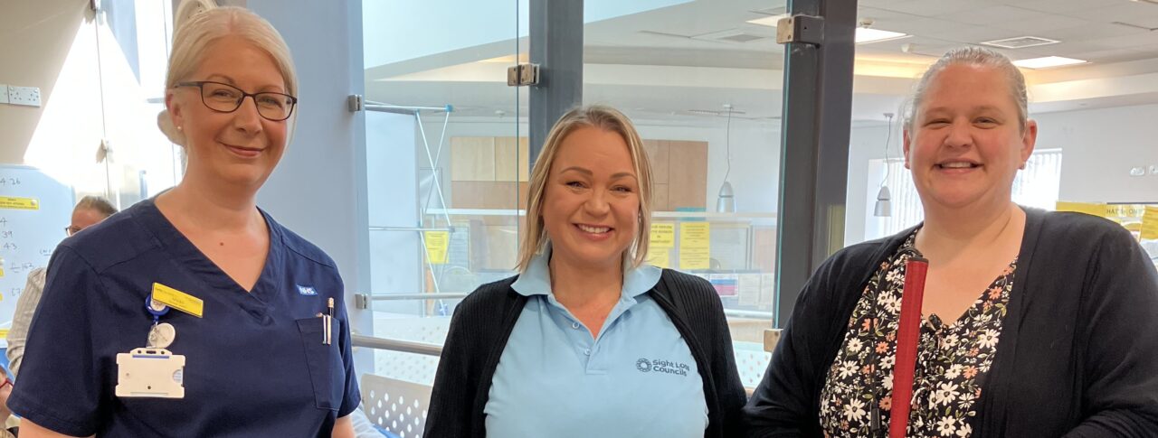 Photo taken at Queens Hospital, Burton, during Patient Experience Week. From left to right: Vicki, Matron, PJ, SLC Coordinator for West Midlands, and Dannie, Derbyshire SLC member. All are facing the camera, smiling.
