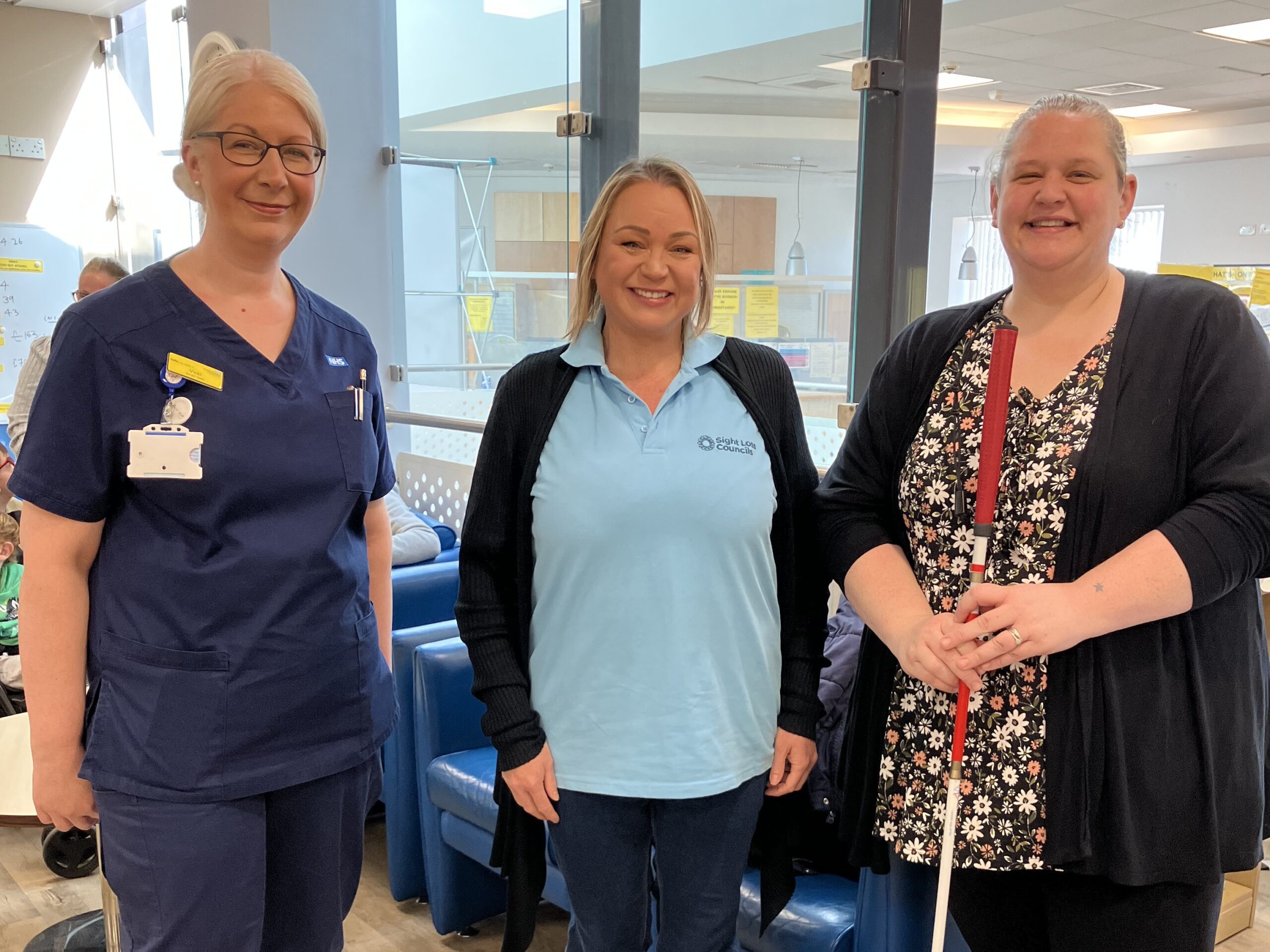 Photo taken at Queens Hospital, Burton, during Patient Experience Week. From left to right: Vicki, Matron, PJ, SLC Coordinator for West Midlands, and Dannie, Derbyshire SLC member. All are facing the camera, smiling.