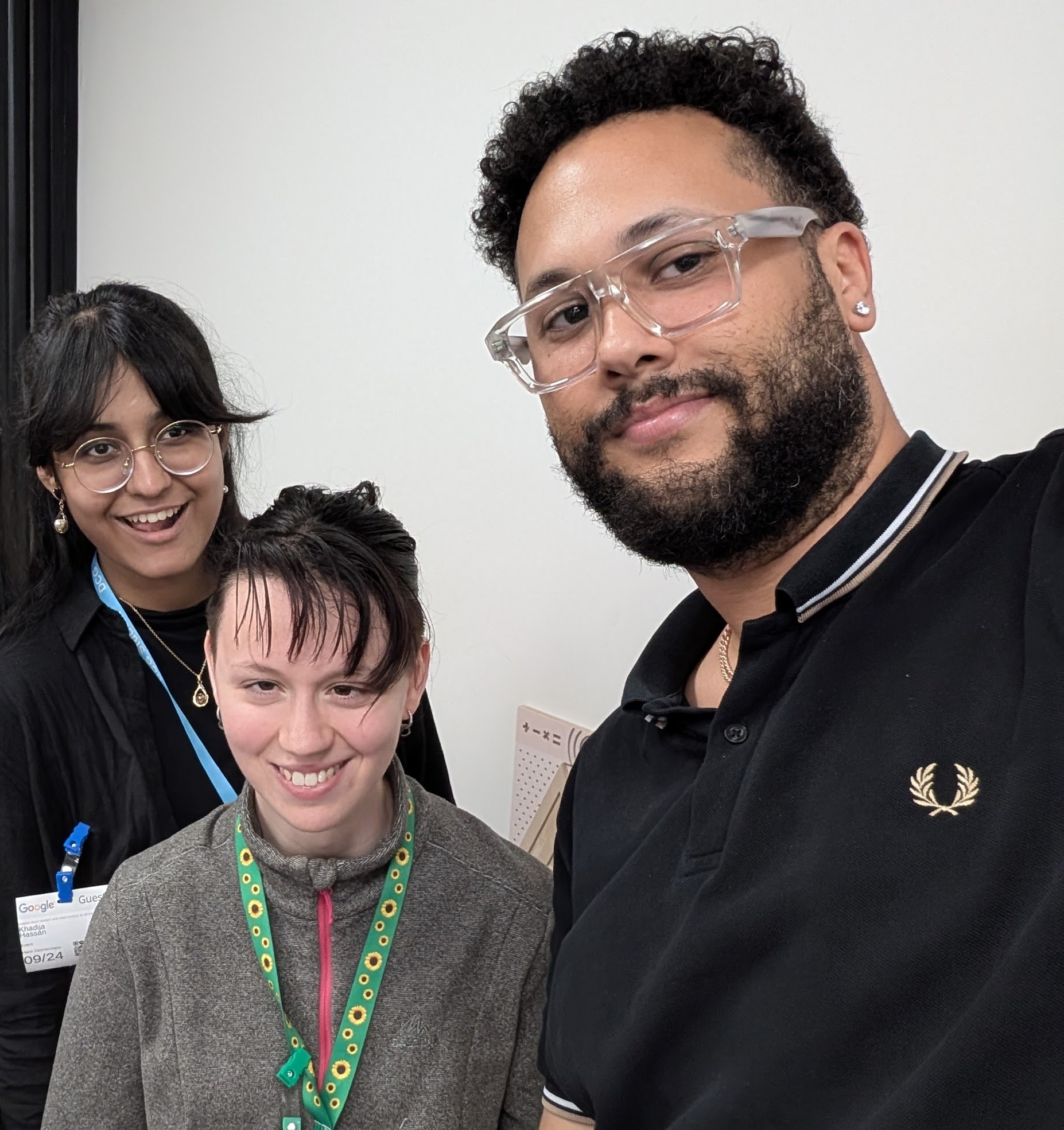 Selfie photo of Khadija and Faith, Student Voices members. A third female is pictured in the background. All are looking at the camera, smiling.