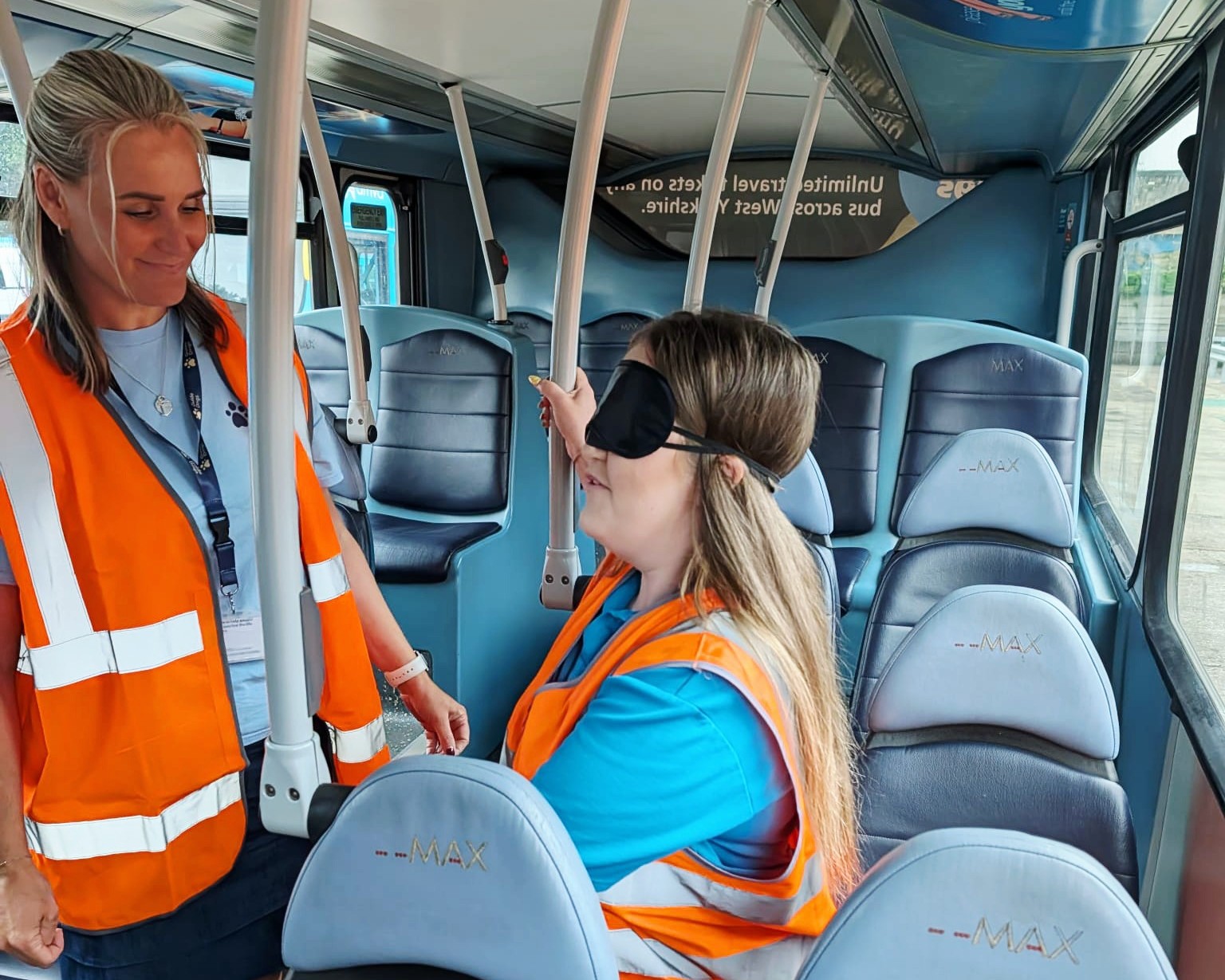 Two female drivers, one in blindfold, one guiding