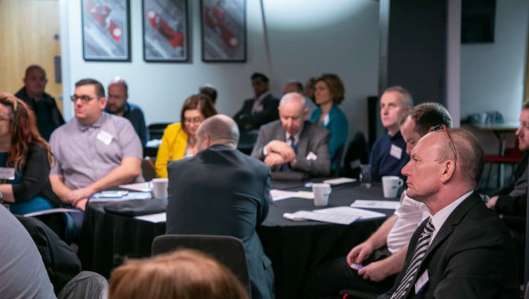 Bridging the gap between employers and visually impaired - people shown in conference setting