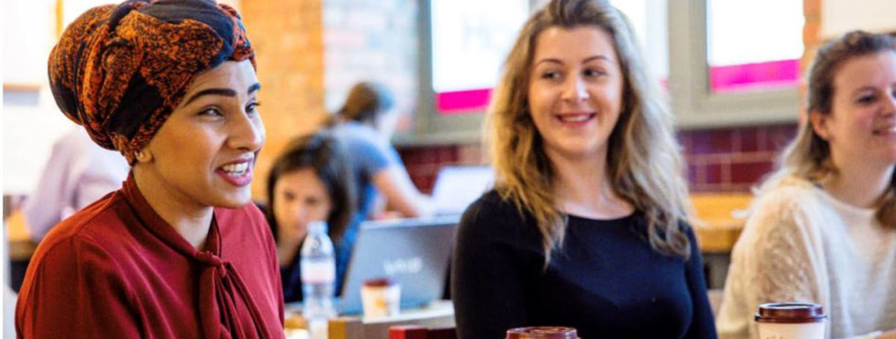 Image showing blind woman and sighted women conversing over coffee in a coffee shop