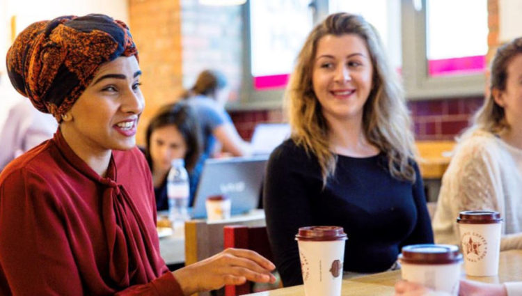 Image showing blind woman and sighted women conversing over coffee in a coffee shop