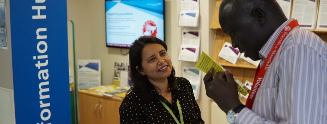 Image showing women interacting with man reading a brochure