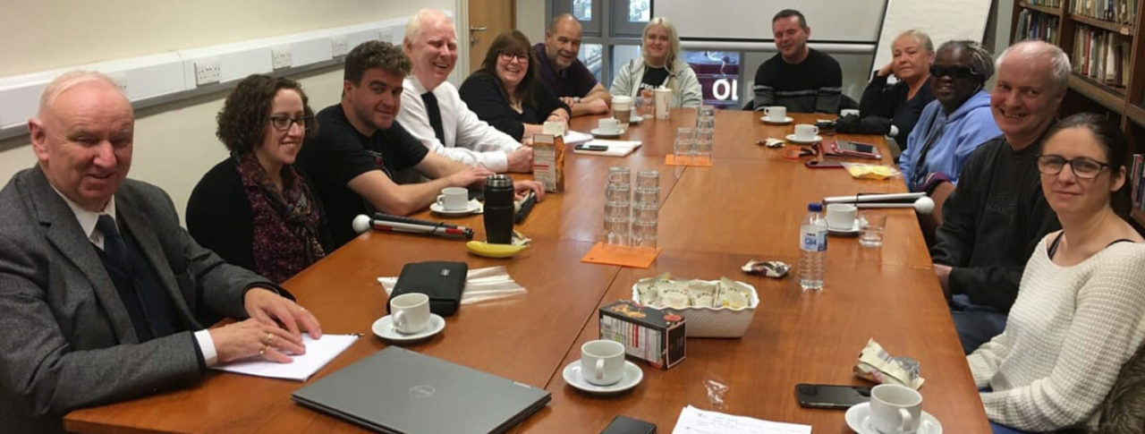 The sight loss council team round a large conference desk