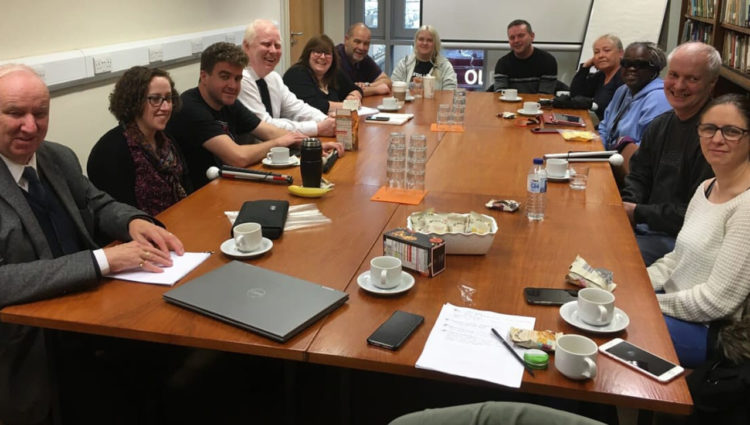 The sight loss council team round a large conference desk