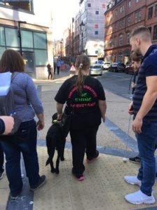 Lianne McKeon walking with a group with a guide dog.