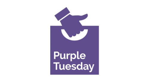 Purple Tuesday Logo - A hand doing a thumbs up holding a carrier bag that reads 'Purple Tuesday'