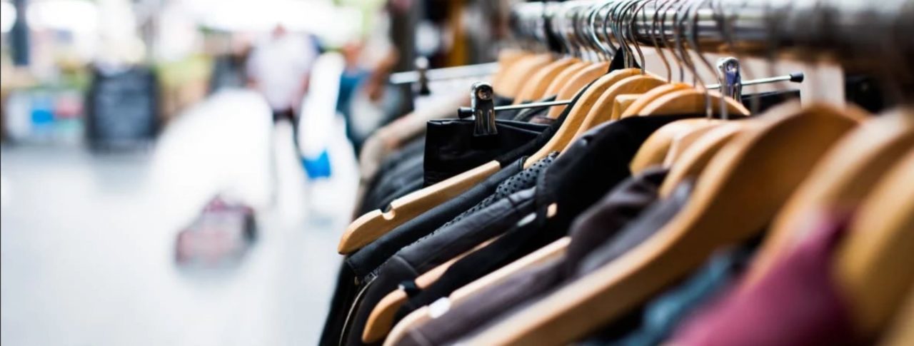 tops of hanging clothes on a shopping rail