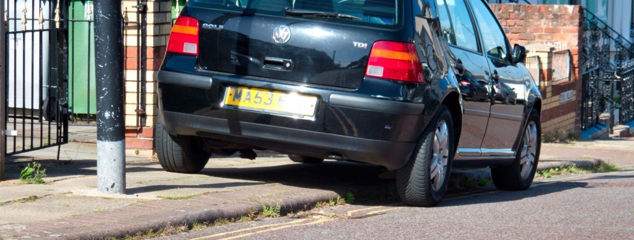 Black car parked on pavement