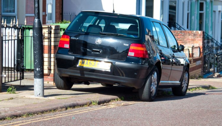 Black car parked on pavement