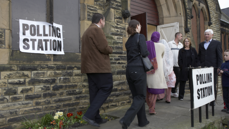 people queuing at poll station