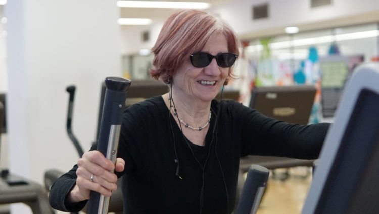 Image of blind person enjoying exercise on a treadmill in a gym