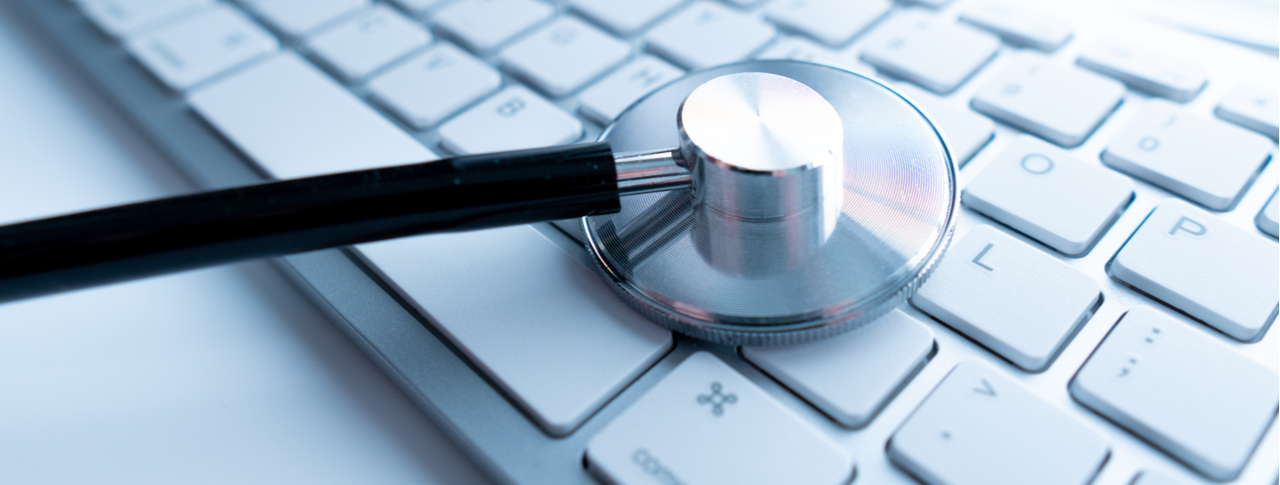 Macro view of a stethoscope on computer keyboard and key button with healthcare