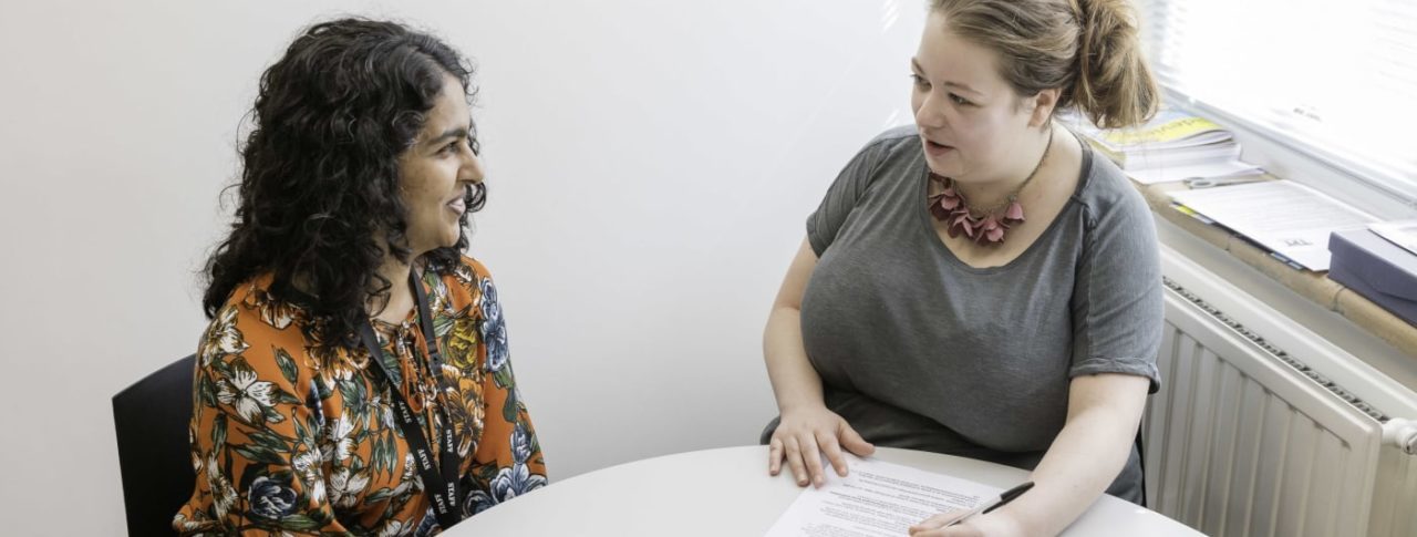 Two women in meeting in small office