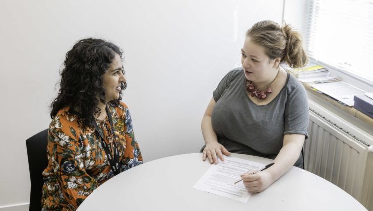 Two women in meeting in small office
