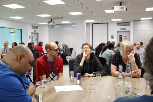 group of SLC members around tables in discusison