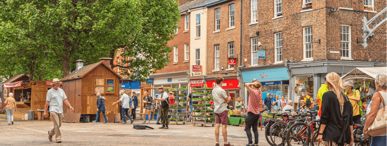 A busy pedestrianised road in York city centre