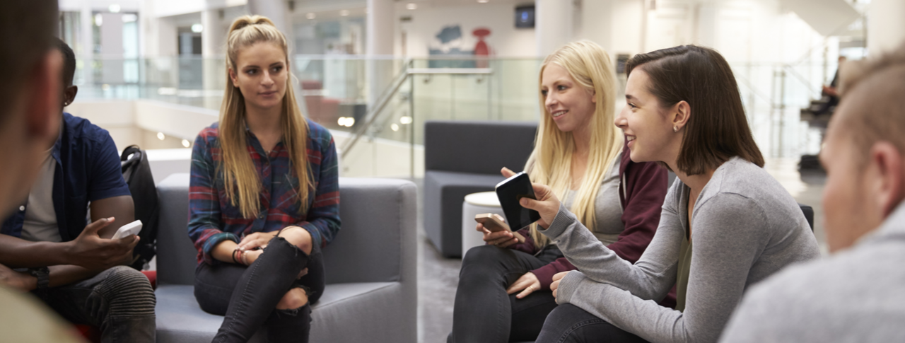 Students meeting in the foyer of modern university building