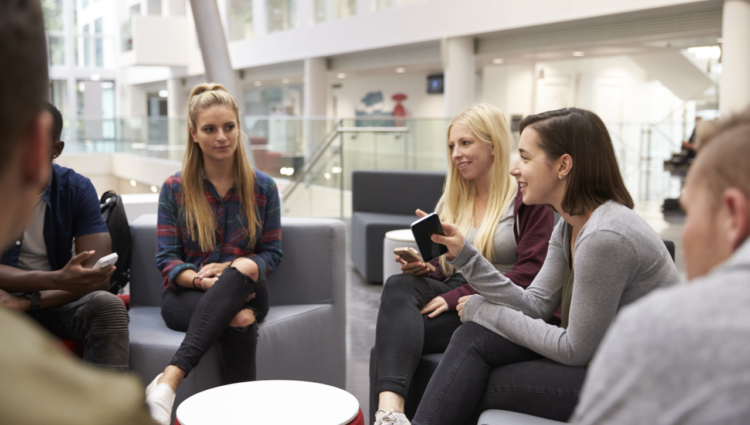 Students meeting in the foyer of modern university building