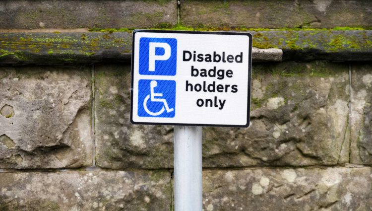 picture of a street sign that reads Disabled badge holders only